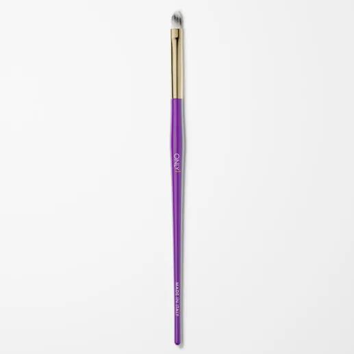 Purple and gold cat tongue makeup brush with white bristles on a plain white background.