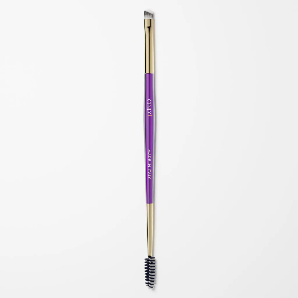 Double-ended eyebrow brush with a purple handle and gold accents, featuring an angled brush on one end and a spoolie on the other, on a plain white background.