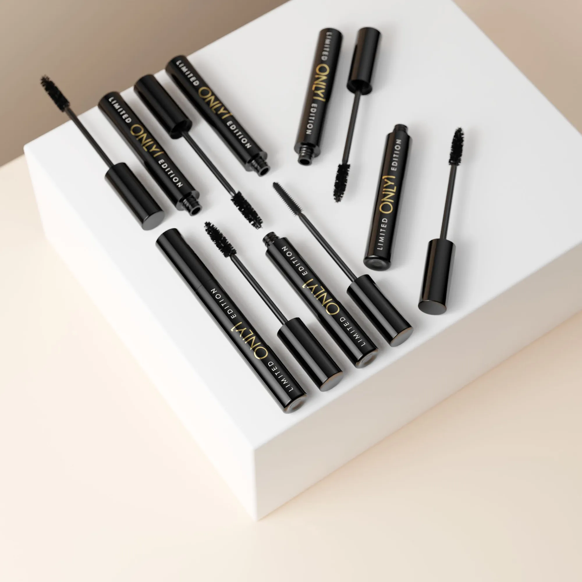 Multiple black mascara tubes and wands arranged on a white geometric pedestal against a beige background.