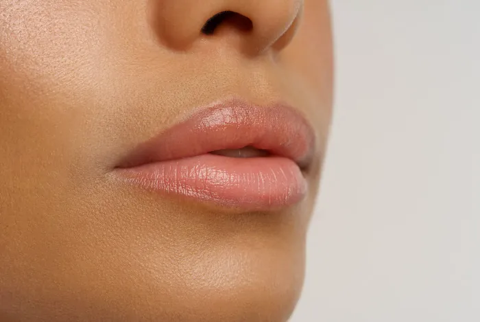 Close-up of soft, healthy lips, indicating someone who knows how to keep lips moisturized and smooth.